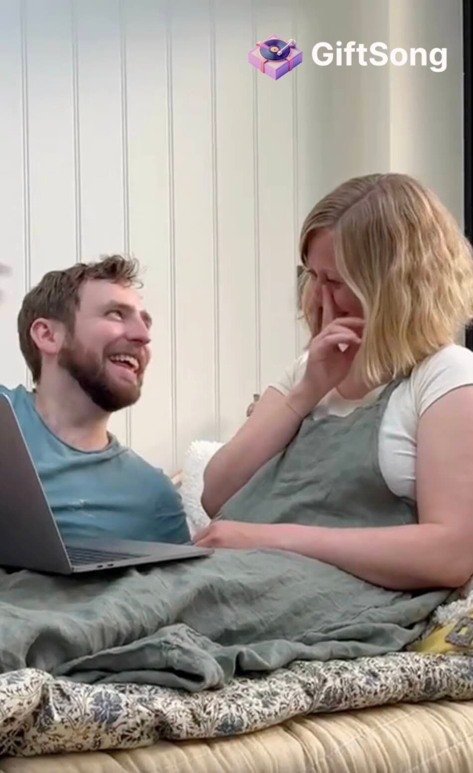 Couple sitting together while listening to a personalized song gift